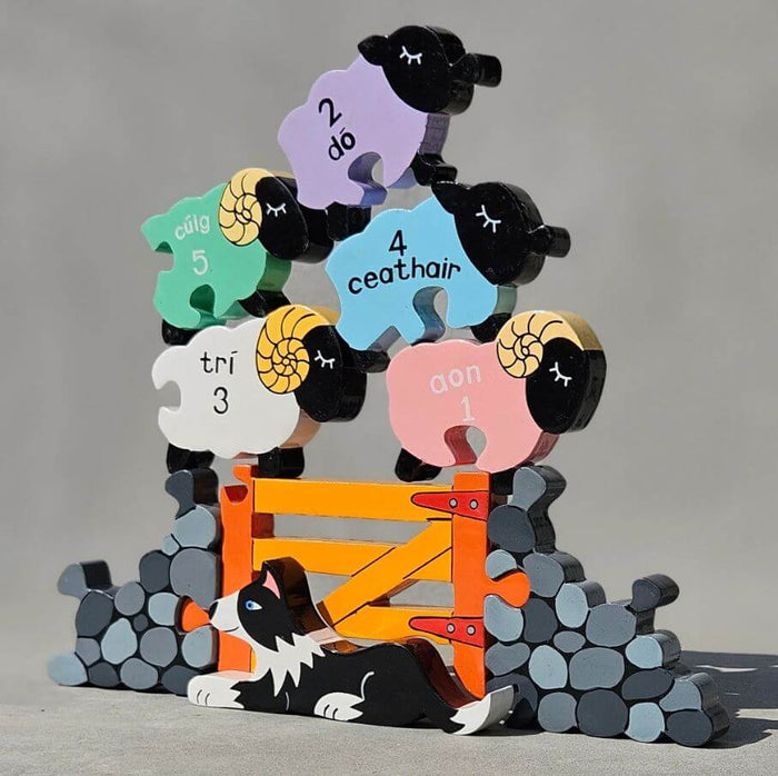 Colorful wooden stacking toy with five sheep featuring Irish number names, an orange gate, and a border collie.