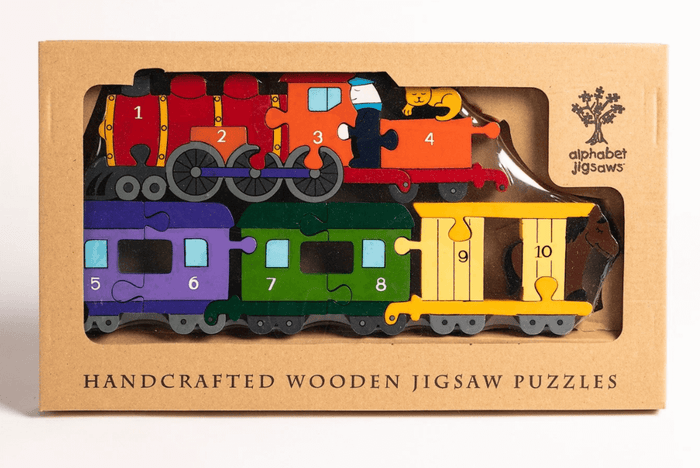 Colorful wooden train jigsaw puzzle with numbered pieces 1-10 inside a brown cardboard window box.
