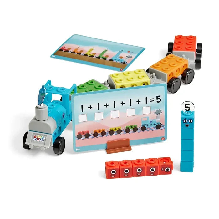 Blue toy train with colorful block carriages, a math addition card, and character blocks with eyes.