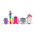 Five colorful Numberblocks toys 6-10: purple spots, rainbow tower, pink octopus, grey square, and red-white rectangle.