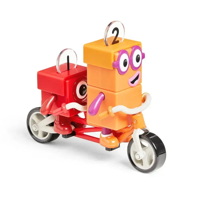 Orange figure Two with purple glasses and red figure One riding an orange and red tandem bike toy.