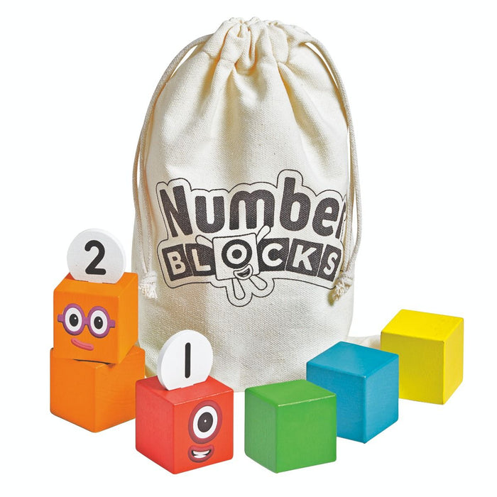 Colorful wooden blocks with character faces and numbers 1 and 2, next to a cream canvas drawstring bag.