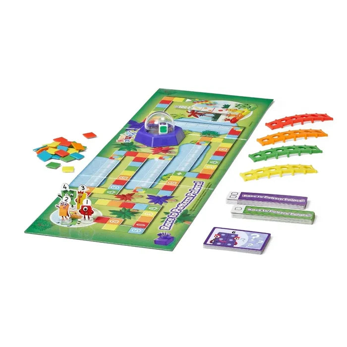 Numberblocks board game with colorful paths, character figures, a purple dice popper, plastic bridges, and cards.