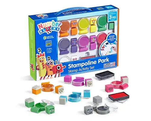 Bright blue toy box featuring block characters and scattered colorful square and circular plastic stamps and ink pads.