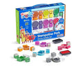 Bright blue toy box featuring block characters and scattered colorful square and circular plastic stamps and ink pads.