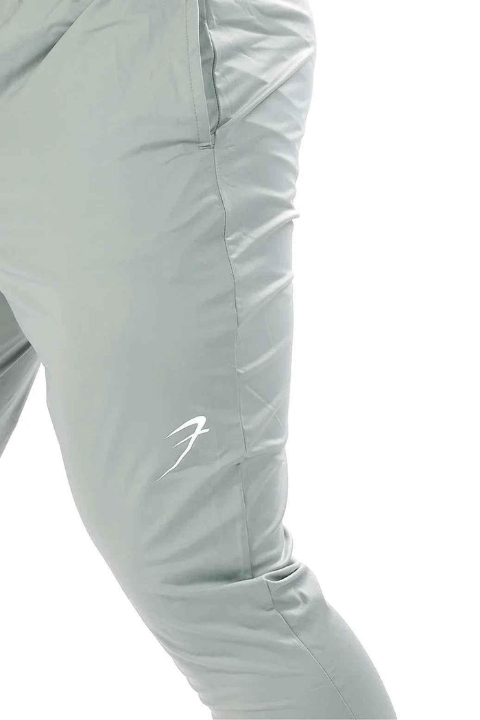 Light grey Nylon Supreme Fuaark Nz track showing the sleek, lightweight fabric and detailed stitching.