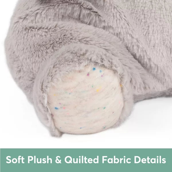 Close-up of a grey plush foot with a cream quilted sole and colorful dots. Text: Soft Plush & Quilted Fabric Details.