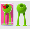Bright green toy with a ball head and two long suction-cup legs, shown next to its clear and pink retail packaging.