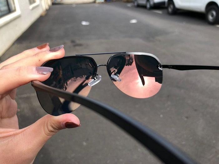 Dealonlinenz polarized HD mirror lens sunglasses with orange frame, anti-blue ray coating and hydrophobic finish, reflecting sunlight.