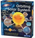 Toy box for a mechanical solar system kit with a translucent yellow sun and colorful orbiting planets on silver arms.