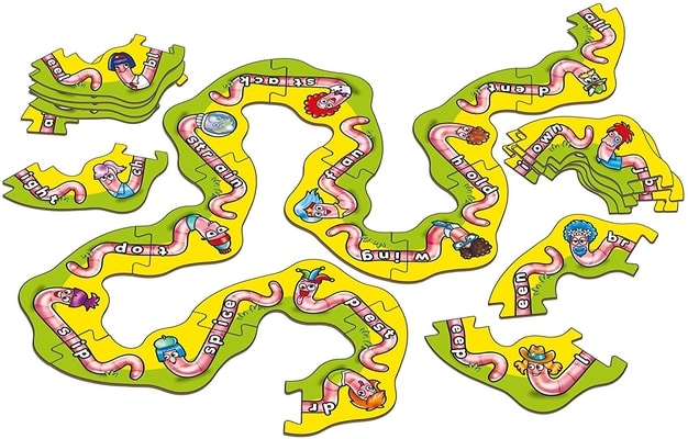 Interlocking path puzzle pieces with pink cartoon worms that use letters on their bodies to spell words.