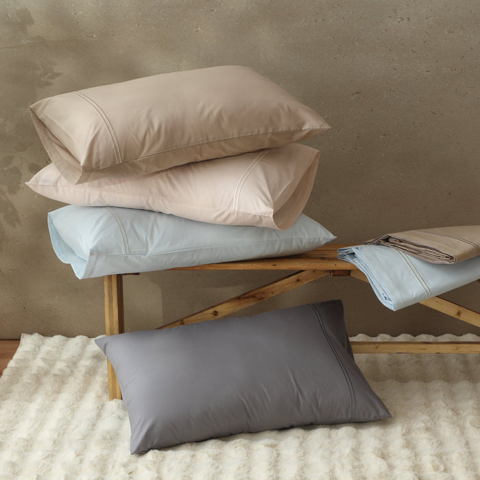 Organic cotton coloured sheet set in dune color from Whites of London NZ, showing the soft, textured fabric on a neatly made bed.