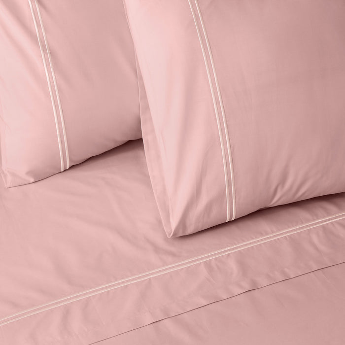 Dusty pink organic cotton sheet set by Whites of London NZ, 250 thread count, showing the soft, pastel-colored bed sheets.