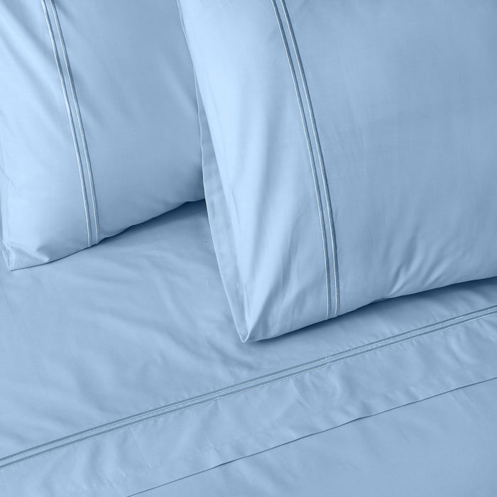 Organic cotton coloured sheet set in estate blue by Whites of London NZ, featuring soft, 250 thread count fabric and a smooth finish.