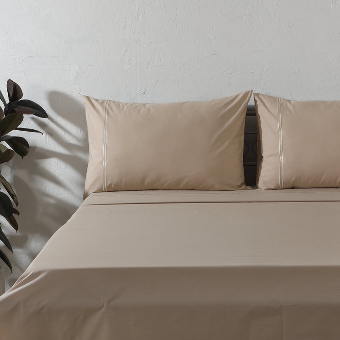 Organic cotton coloured sheet set in hummus, 250 thread count, from Whites of London NZ, showing neatly folded bedsheets.
