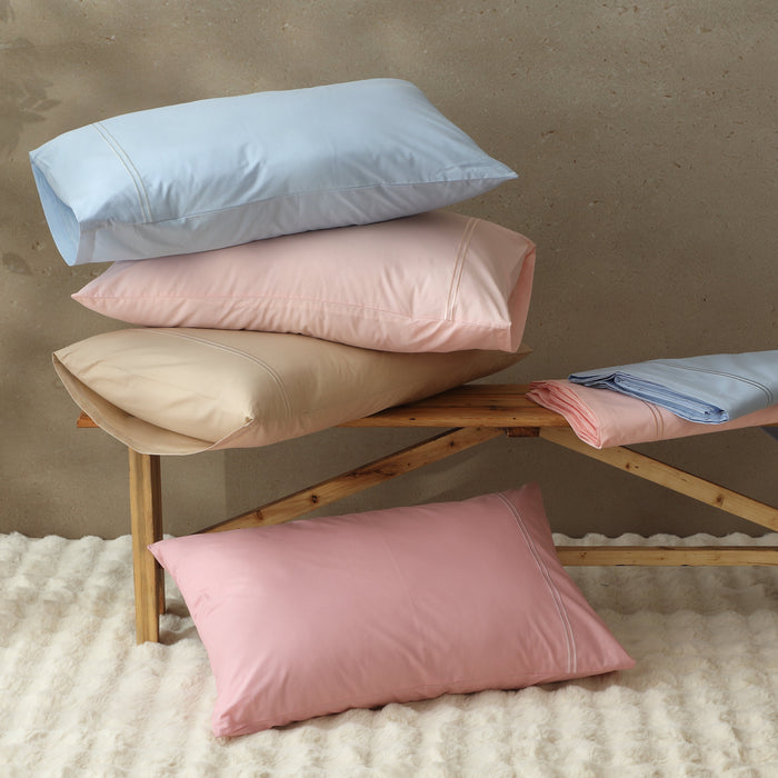 Organic cotton coloured sheet set with peach fuzz embroidery, featuring 250TC weave from Whites of London NZ, includes fitted and flat sheets.