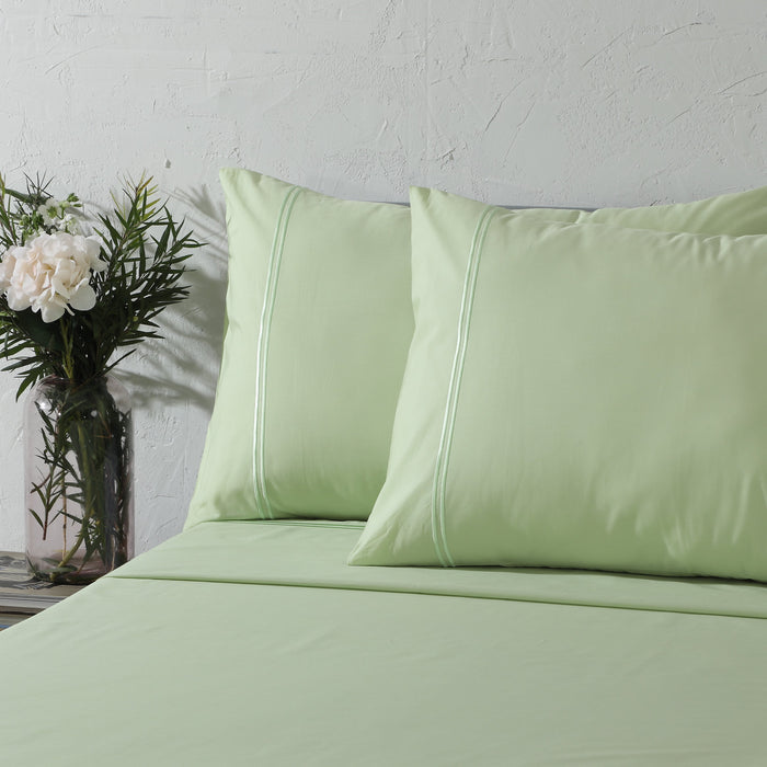 Organic cotton coloured sheet set in reef blue with 250 thread count, featuring neatly folded sheets and pillowcases.