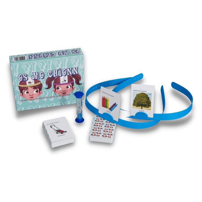 Teal game box, blue headbands with picture cards, decks of cards, and a blue sand timer for an Irish language game.