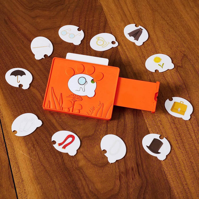 Orange fox clue decoder surrounded by twelve white clue tokens with various icons on a wooden table.