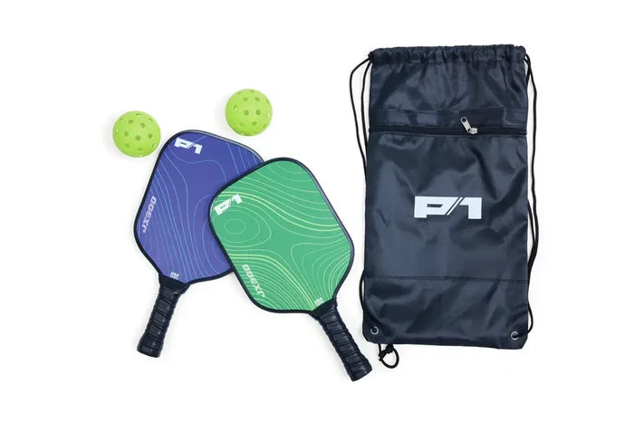 Blue and green pickleball paddles with wavy patterns, two neon balls, and a black drawstring bag with a white P1 logo.