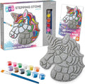 Unicorn craft kit with a gray textured stone, 12 colorful paint pots, and a paintbrush shown with its packaging.
