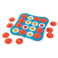 Blue square board with 16 emoji faces in a grid and orange cone-shaped covers scattered on and around it.