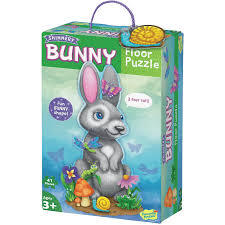 Box for a bunny-shaped floor puzzle featuring a grey rabbit illustration, flowers, and a purple carry handle.