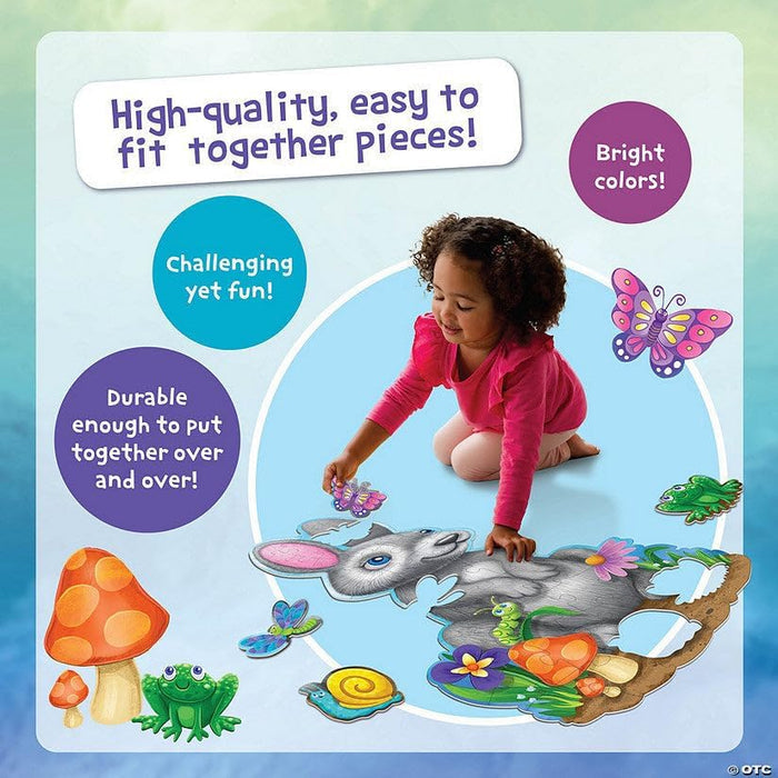Girl assembling a large shimmery bunny floor puzzle featuring colorful butterfly and frog accents.