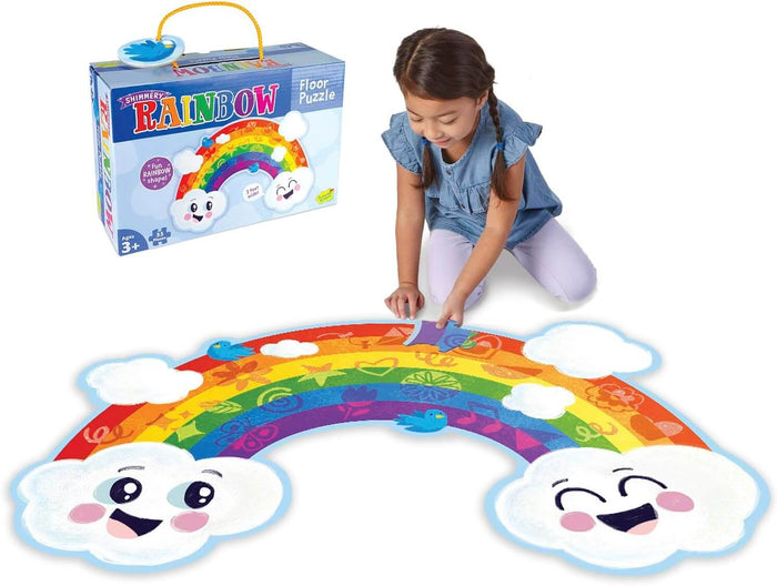 Child assembles a large rainbow-shaped floor puzzle with smiling clouds and icons; product box shown in background.