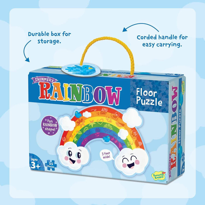 Blue box for rainbow floor puzzle with yellow cord handle, featuring a colorful arched rainbow and smiling clouds.