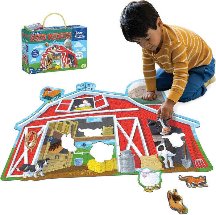 Child assembling a barn-shaped floor puzzle with farm animal pieces next to its blue and yellow storage box.