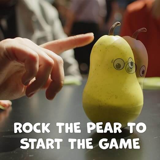 Finger nudging a yellow pear-shaped toy with a face. Text reads: ROCK THE PEAR TO START THE GAME.
