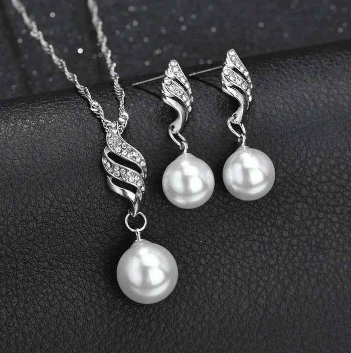 Elegant pearl jewelry gift set by Stylish 3Sixty5 featuring gold-toned necklaces and earrings arranged stylishly.