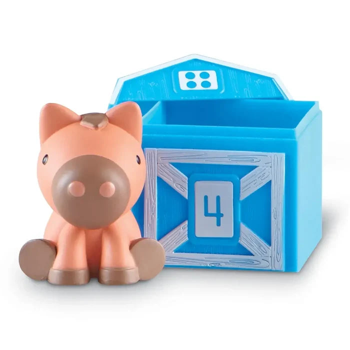 Tan toy horse with brown accents next to a blue barn-shaped container with grey doors and the number 4.