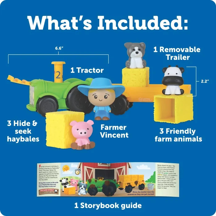 Toy set with green tractor, yellow trailer, farmer, three animals, three yellow haybales, and a storybook guide.