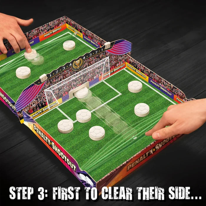Two hands flick white soccer pucks across a green field board through a central goal in a tabletop game.