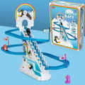 Blue and white penguin race toy with spiral slides, stairs, and penguin figures next to its colorful retro box.