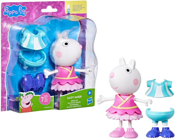White sheep toy in a pink tutu with extra blue outfit pieces and purple shoes, beside the product packaging.