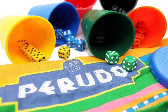 Colorful dice and cups spilling out onto a striped fabric bag with the Perudo game logo.