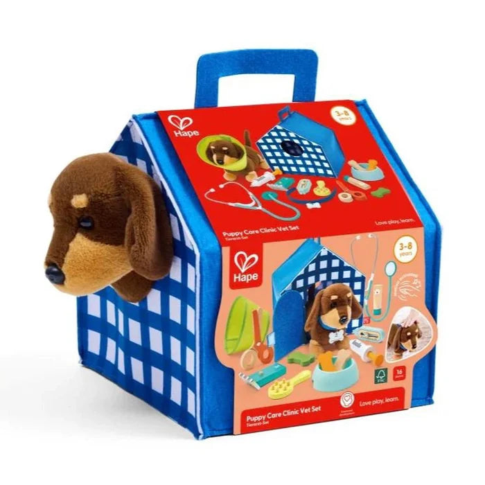 Blue house-shaped toy vet carrier with a brown plush puppy head poking out and images of medical tools.