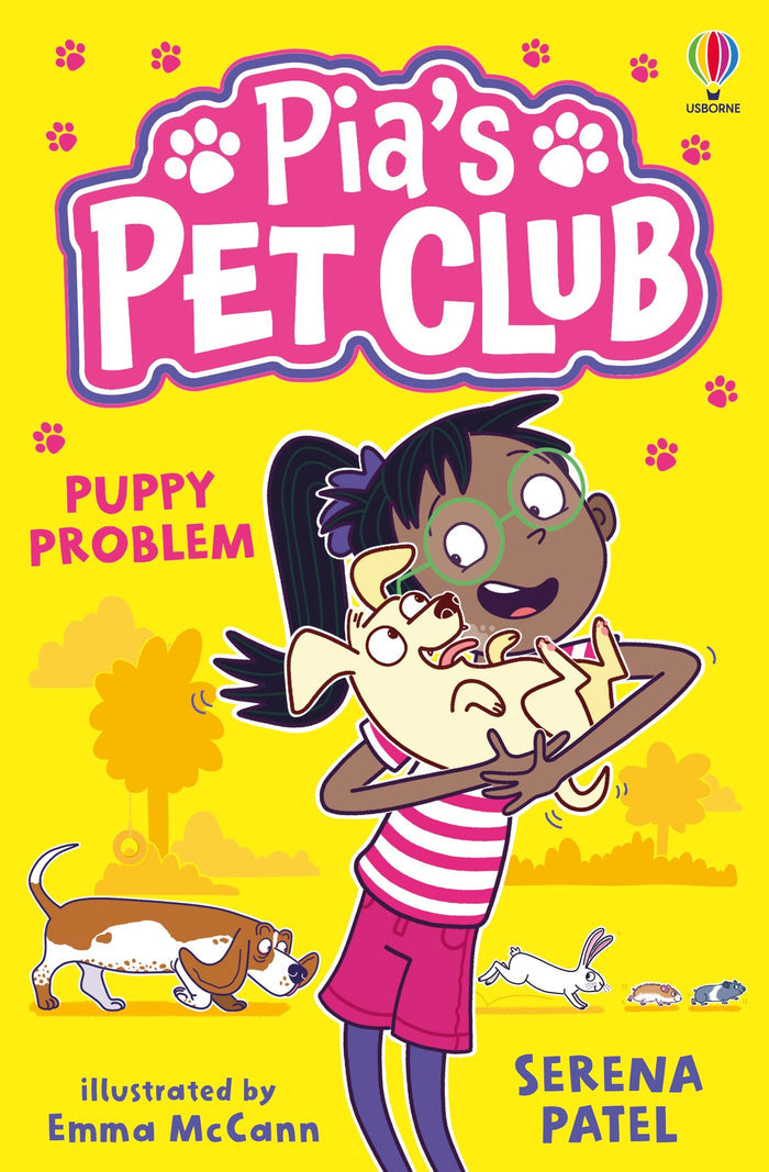 Children's book cover: girl in green glasses holds a puppy on a yellow background with a basset hound and rabbit.
