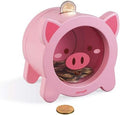 Round pink wooden piggy bank with a transparent window filled with coins and a coin slot on top.