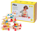 Wooden planks balanced on colorful red, blue, and yellow silicone cones next to a yellow toy box.