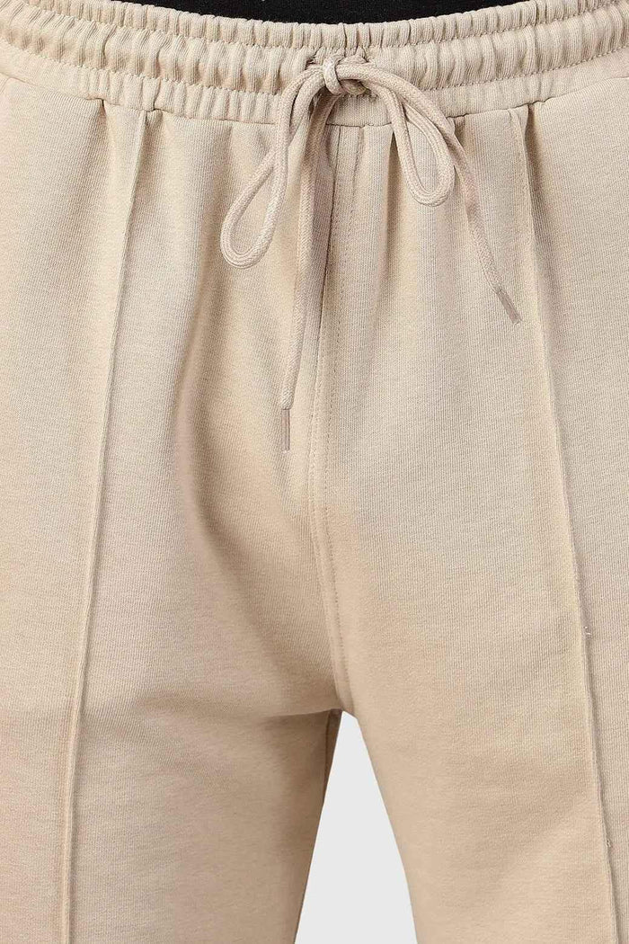 Beige Pinnacle Straight Pants joggers by Fuaark Nz, featuring a relaxed fit and casual style, shown on a model.