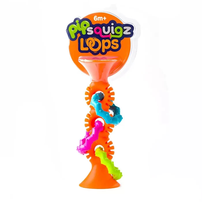 Orange suction cup toy with three colorful textured rings in blue, pink, and green, shown in retail packaging.