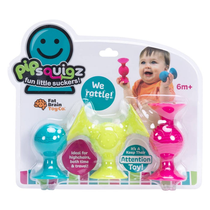 Three colorful, textured silicone suction rattles in teal, lime green, and pink packaging for babies 6 months+.