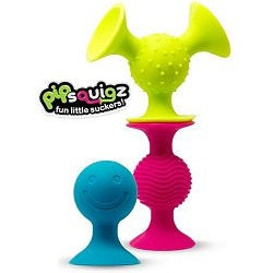 Three colorful silicone suction toys in lime green, pink, and blue with various textures and a smiley face.