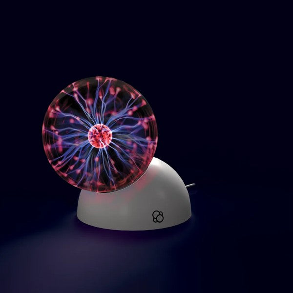 Plasma ball with pink and purple electric filaments inside a glass sphere on a white, dome-shaped base.