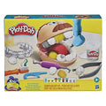 Yellow toy box featuring a tan head with an open mouth, clay teeth, blue drill, and various plastic dental tools.