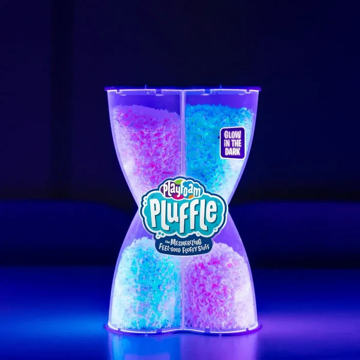 Clear hourglass container filled with glowing pink and blue fluffy foam material under a blacklight.